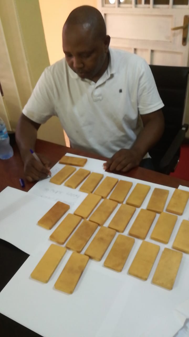Representative holding a refined gold bar